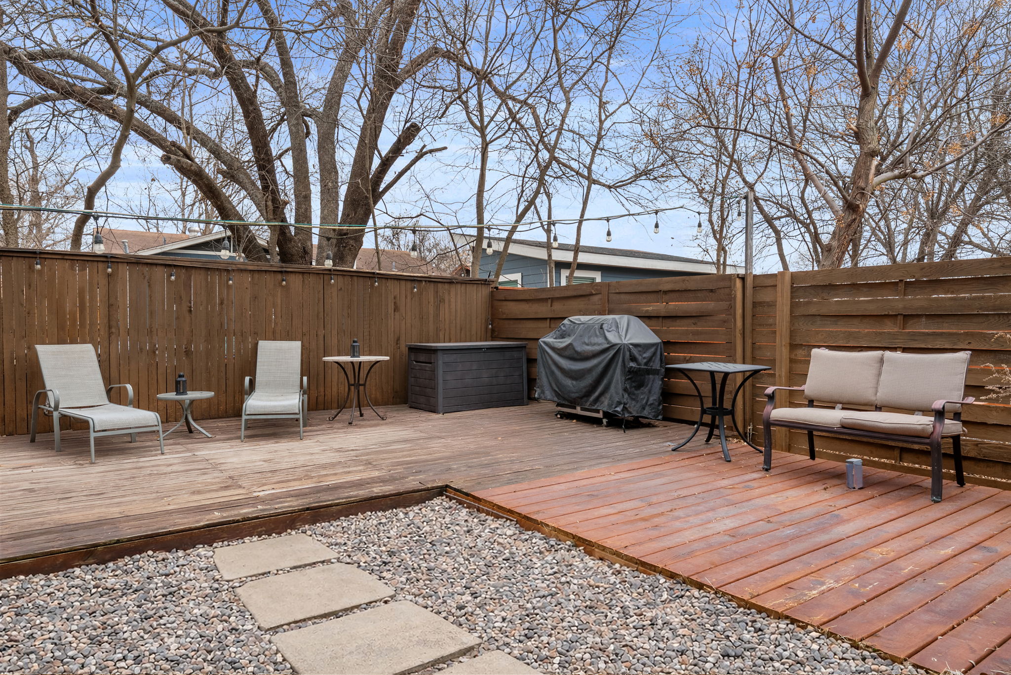 1501 Homespun Road Austin, TX 78745 - Photo 7 of 33 Wooden terrace with area for grilling and a fenced backyard