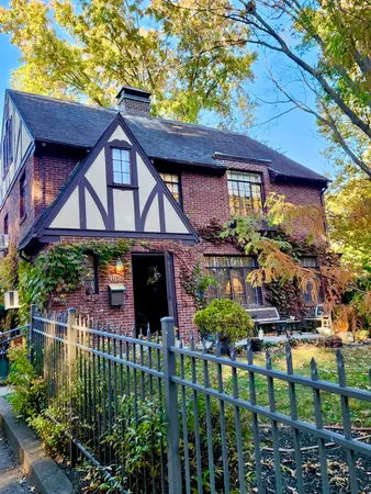 a front view of a house with a garden