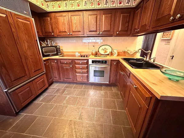 a kitchen with stainless steel appliances a stove a sink and a microwave