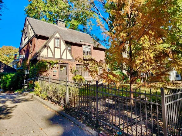 a view of a house with a tree in front