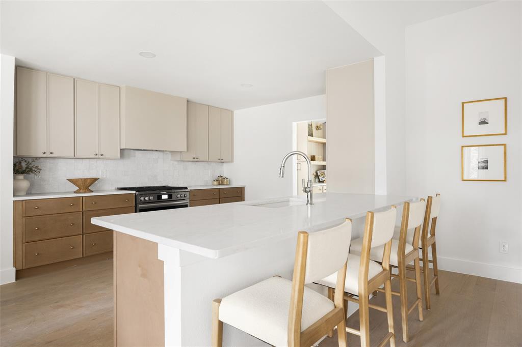 16805 Deer Park Drive Dallas, TX 75248 - Photo 12 of 39 a kitchen with a table chairs and white cabinets