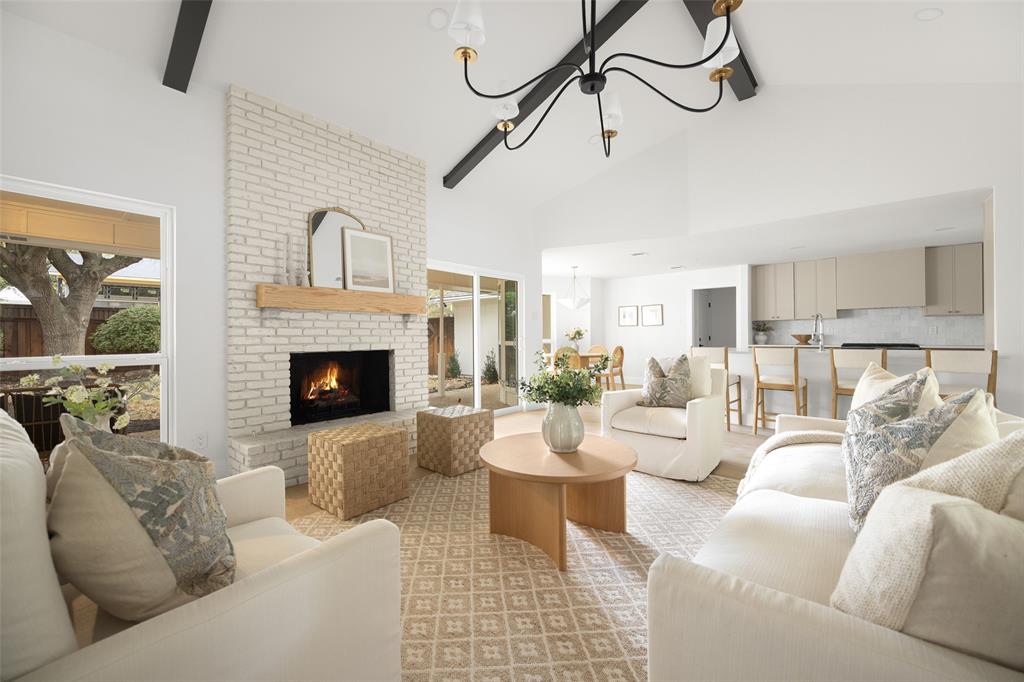 16805 Deer Park Drive Dallas, TX 75248 - Photo 2 of 39 a living room with furniture a fireplace and a chandelier