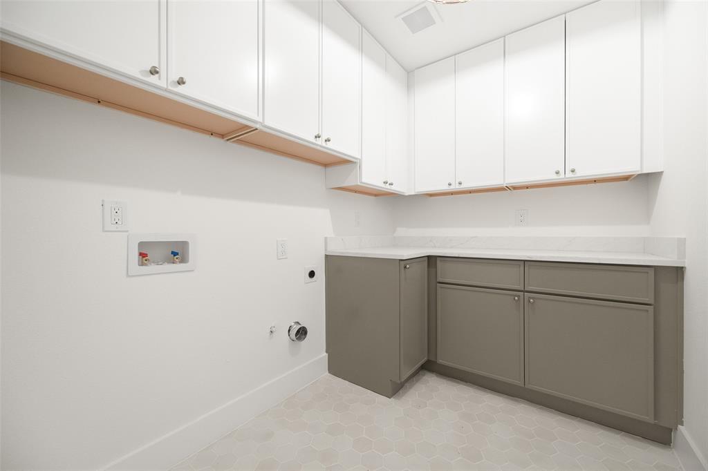 16805 Deer Park Drive Dallas, TX 75248 - Photo 36 of 39 a kitchen with cabinets and white countertops