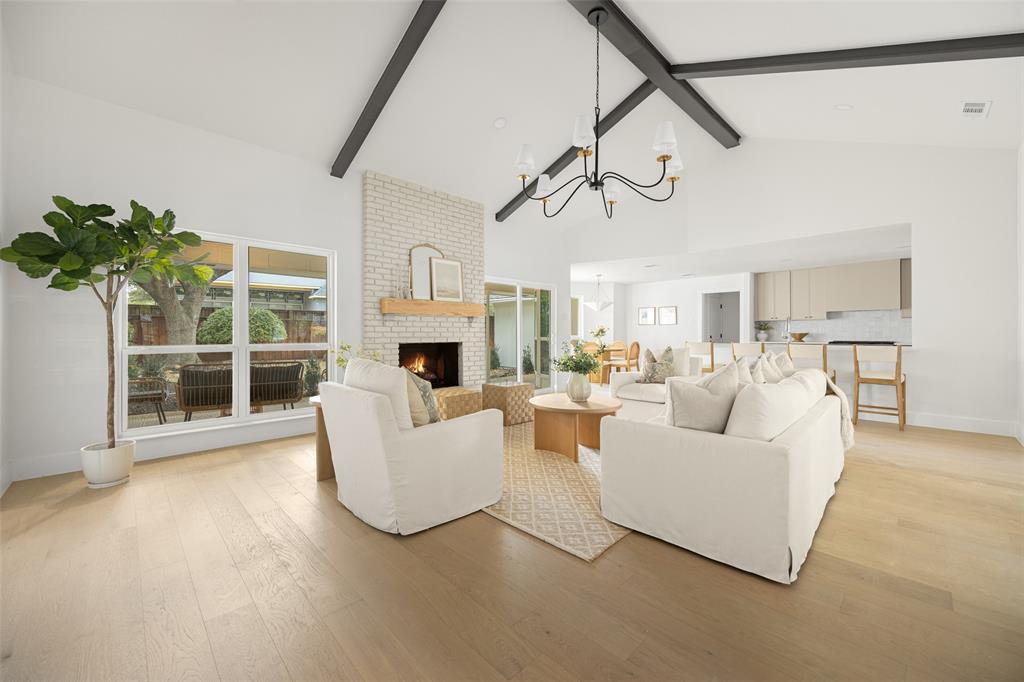 16805 Deer Park Drive Dallas, TX 75248 - Photo 8 of 39 a living room with furniture a chandelier and a flat screen tv