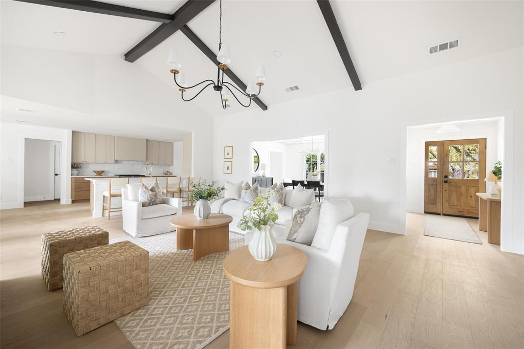 16805 Deer Park Drive Dallas, TX 75248 - Photo 10 of 39 a view of a dining room with furniture wooden floor and a chandelier