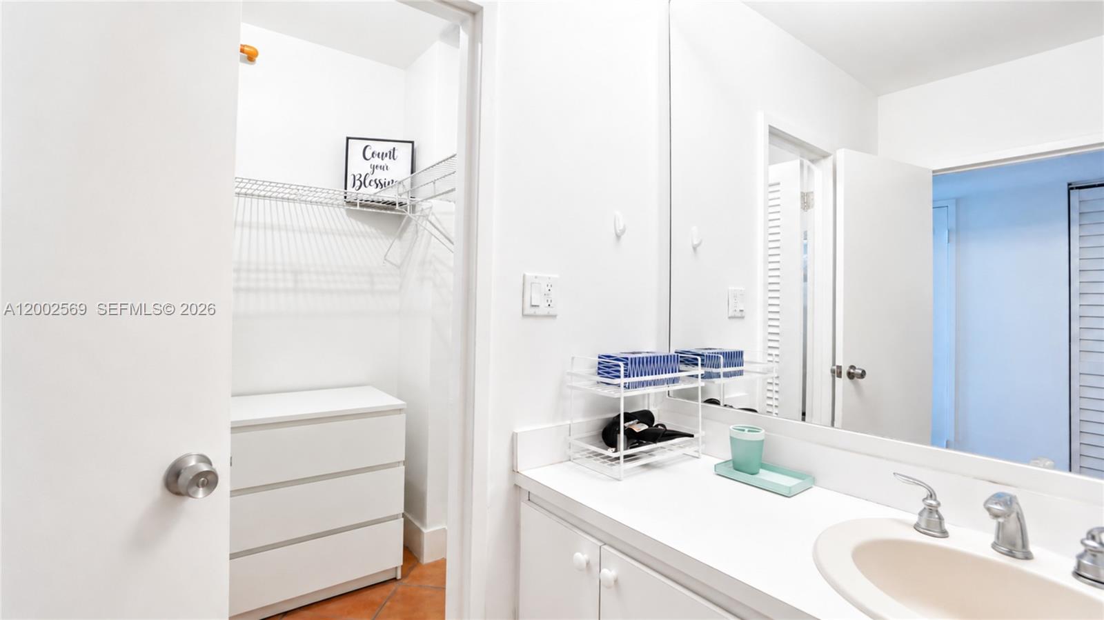 100 Lincoln Road, Unit 1209 Miami Beach, FL 33139 - Photo 12 of 25 a bathroom with a sink and a mirror