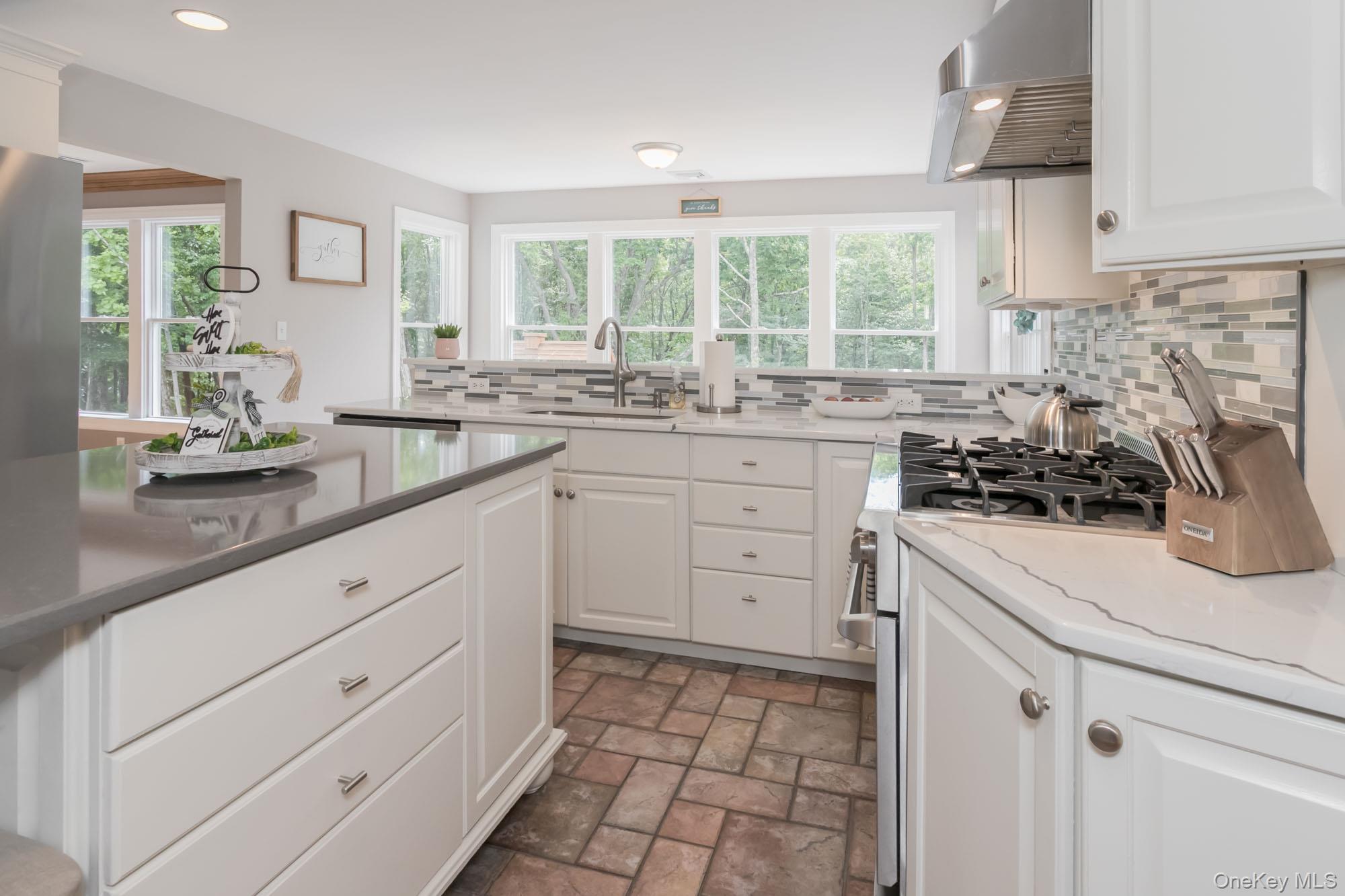 102 Beverly Road Chester, NY 10918 - Photo 9 of 49 a kitchen with white cabinets and appliances