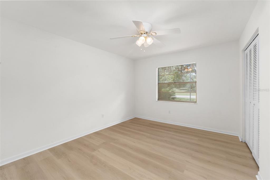 4825 Southwest 19th Street Gainesville, FL 32608 - Photo 19 of 40 wooden floor in an empty room with a window