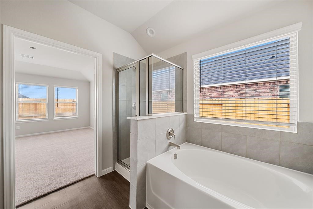 2103 Spring Hollow Drive Baytown, TX 77521 - Photo 16 of 27 a bathroom with a bathtub and a shower