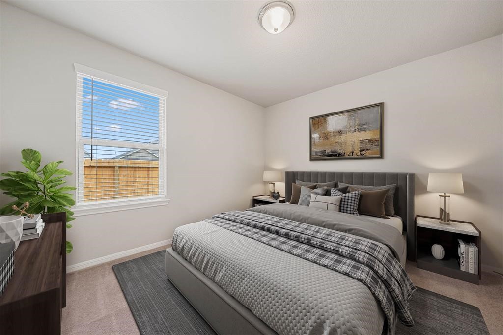 2103 Spring Hollow Drive Baytown, TX 77521 - Photo 17 of 27 a bedroom with a bed and a potted plant