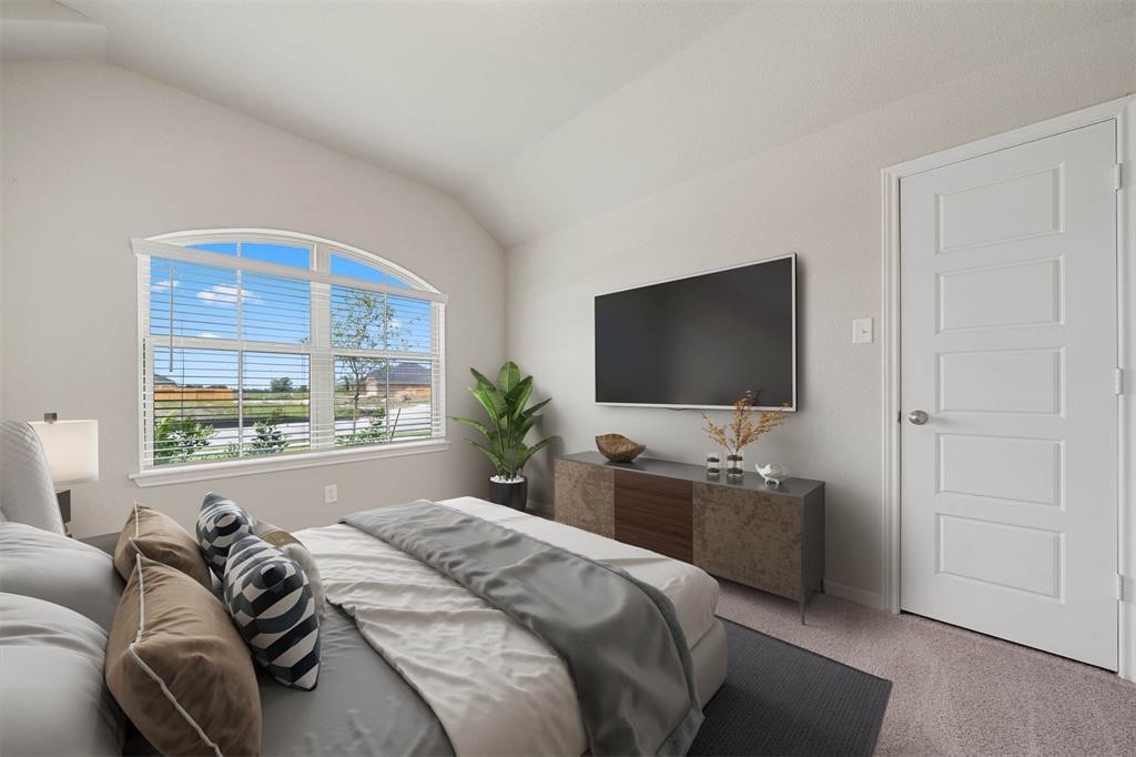 2103 Spring Hollow Drive Baytown, TX 77521 - Photo 20 of 27 a bedroom with a bed and a flat screen tv