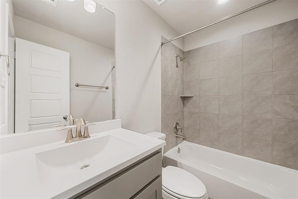 2103 Spring Hollow Drive Baytown, TX 77521 - Photo 22 of 27 a bathroom with a sink toilet and shower