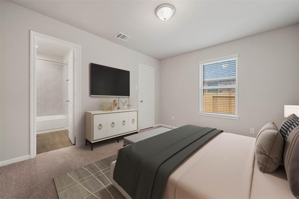 2103 Spring Hollow Drive Baytown, TX 77521 - Photo 23 of 27 a bedroom with a bed and a flat tv screen on dresser