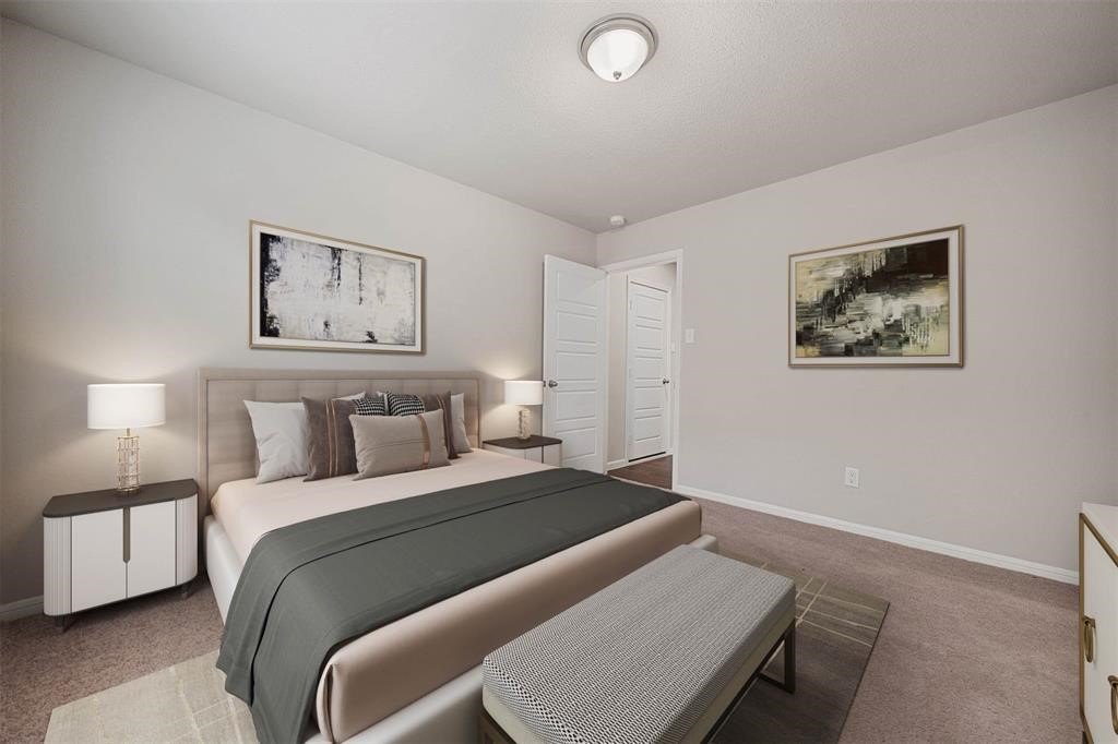 2103 Spring Hollow Drive Baytown, TX 77521 - Photo 24 of 27 a bedroom with a bed and a lamp on table