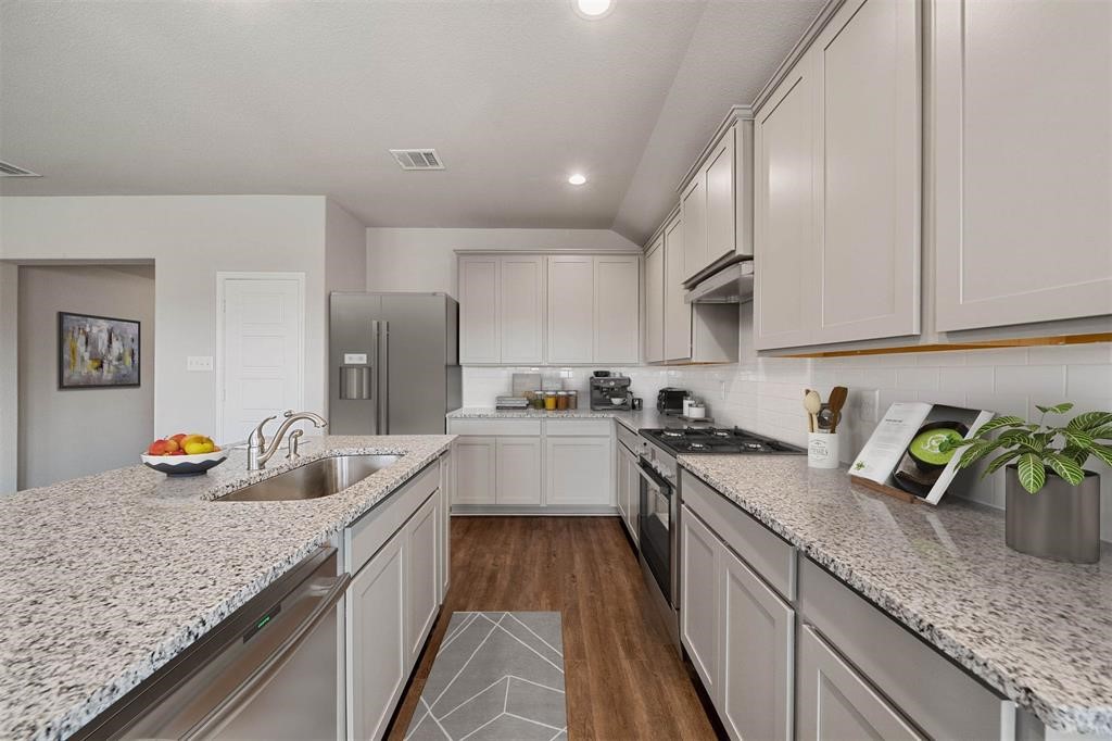 2103 Spring Hollow Drive Baytown, TX 77521 - Photo 10 of 27 a kitchen with granite countertop lots of counter top space and stainless steel appliances