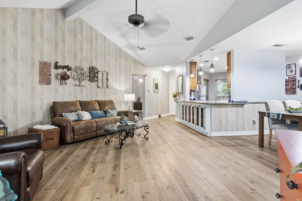 9211 Benwick Street Spring, TX 77379 - Photo 7 of 27 a living room with furniture and wooden floor