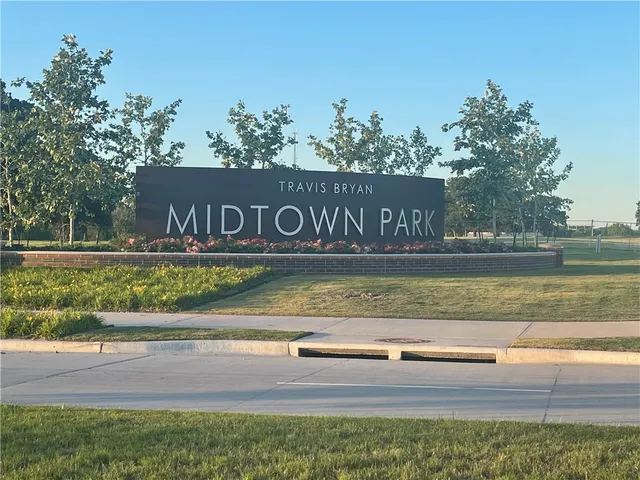 a view of swimming pool with a yard and large trees
