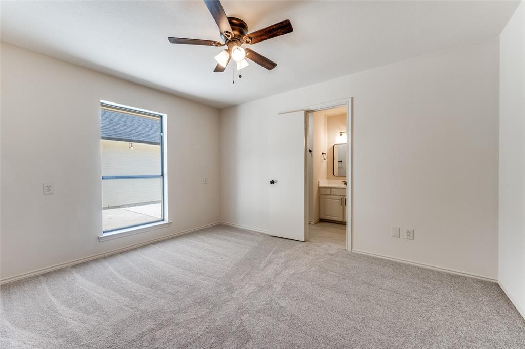 10422 Strittmatter Road Pilot Point, TX 76258 - Photo 11 of 30 an empty room with a ceiling fan and a window