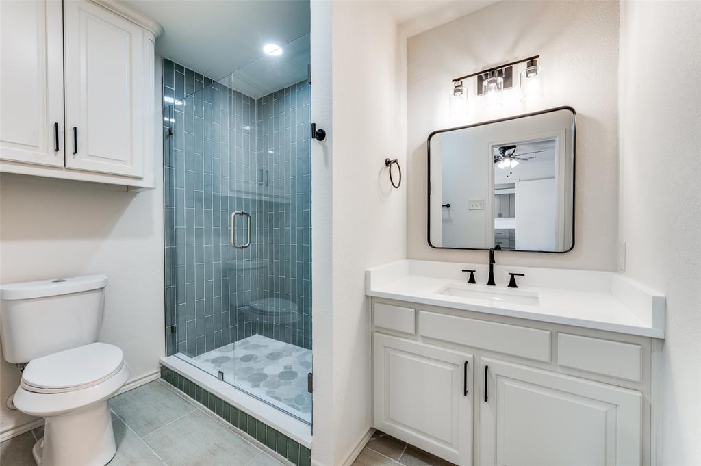 10422 Strittmatter Road Pilot Point, TX 76258 - Photo 12 of 30 a bathroom with a toilet sink a shower and