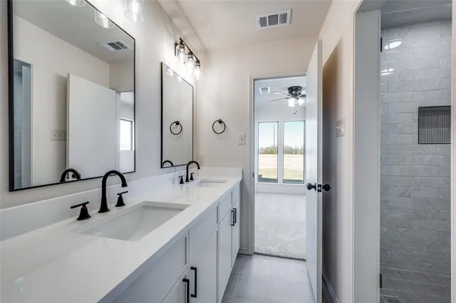 a bathroom with a double vanity sink mirror and double