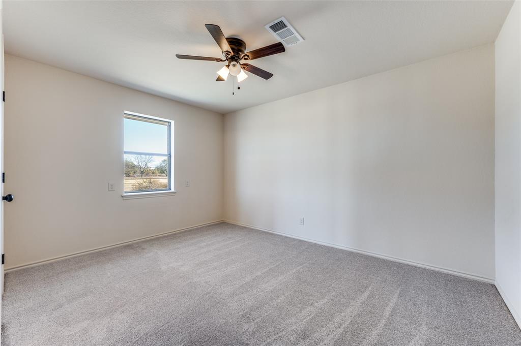 10422 Strittmatter Road Pilot Point, TX 76258 - Photo 15 of 30 an empty room with a window and a fan