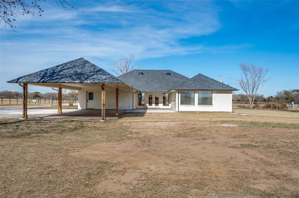 10422 Strittmatter Road Pilot Point, TX 76258 - Photo 18 of 30 a front view of a house with a garden