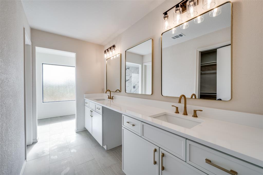 10422 Strittmatter Road Pilot Point, TX 76258 - Photo 9 of 30 a bathroom with a double vanity sink mirror and double