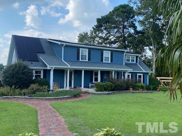 3614 Holly Grove Road Benson, NC 27504 - Photo 2 of 30 a front view of a house with garden and trees