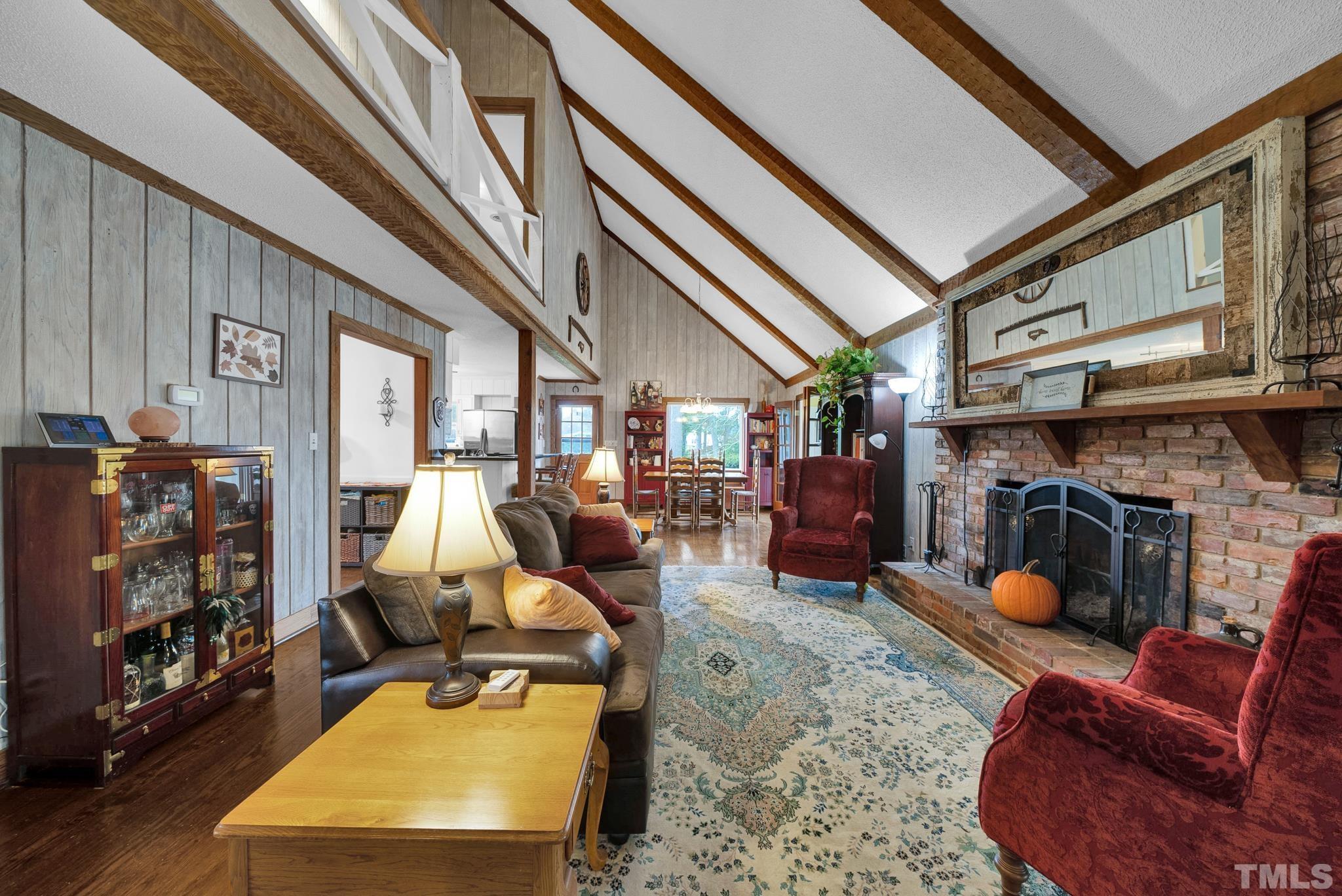 3614 Holly Grove Road Benson, NC 27504 - Photo 13 of 30 a room with furniture a fireplace and a chandelier