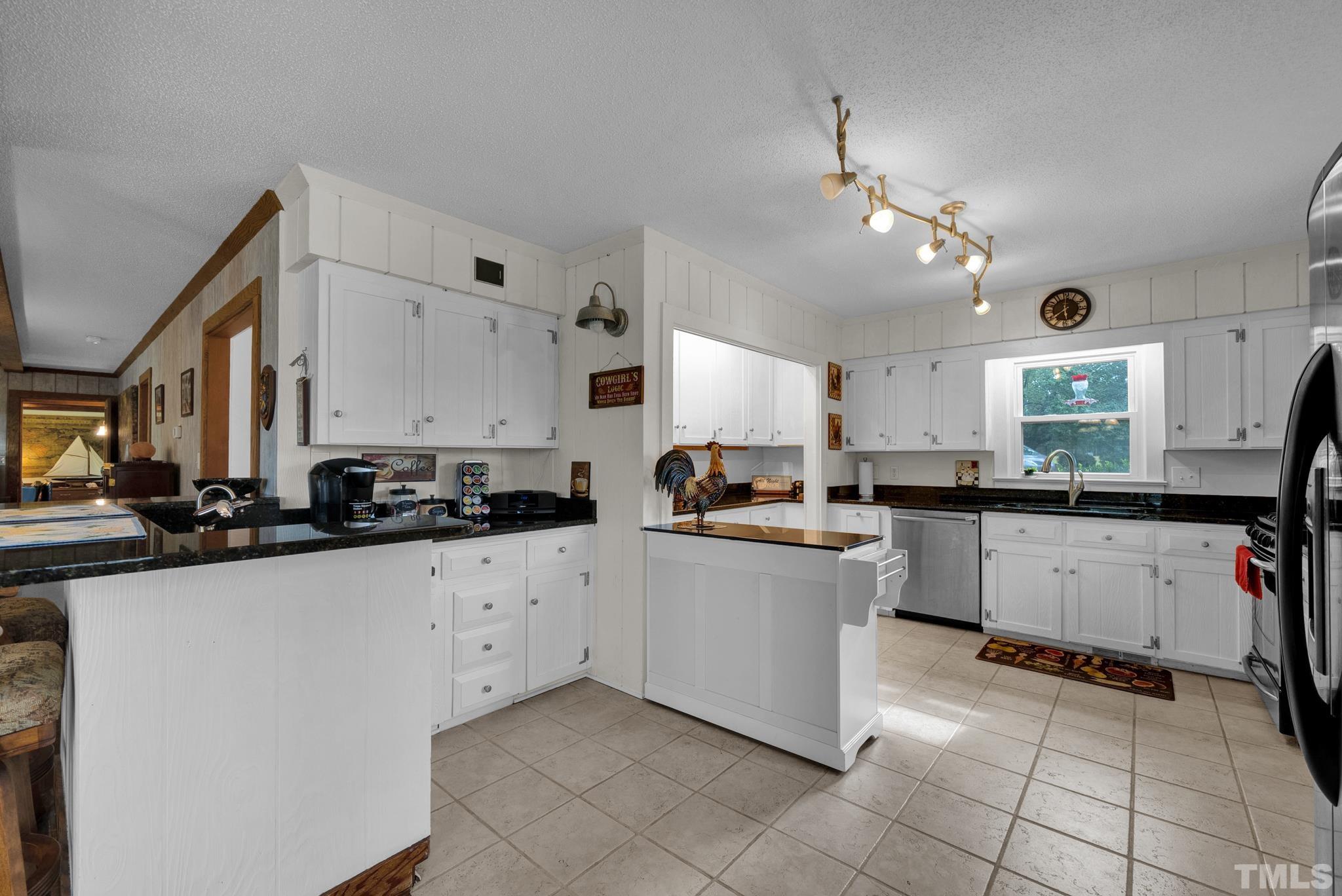 3614 Holly Grove Road Benson, NC 27504 - Photo 18 of 30 a kitchen with a sink window and cabinets