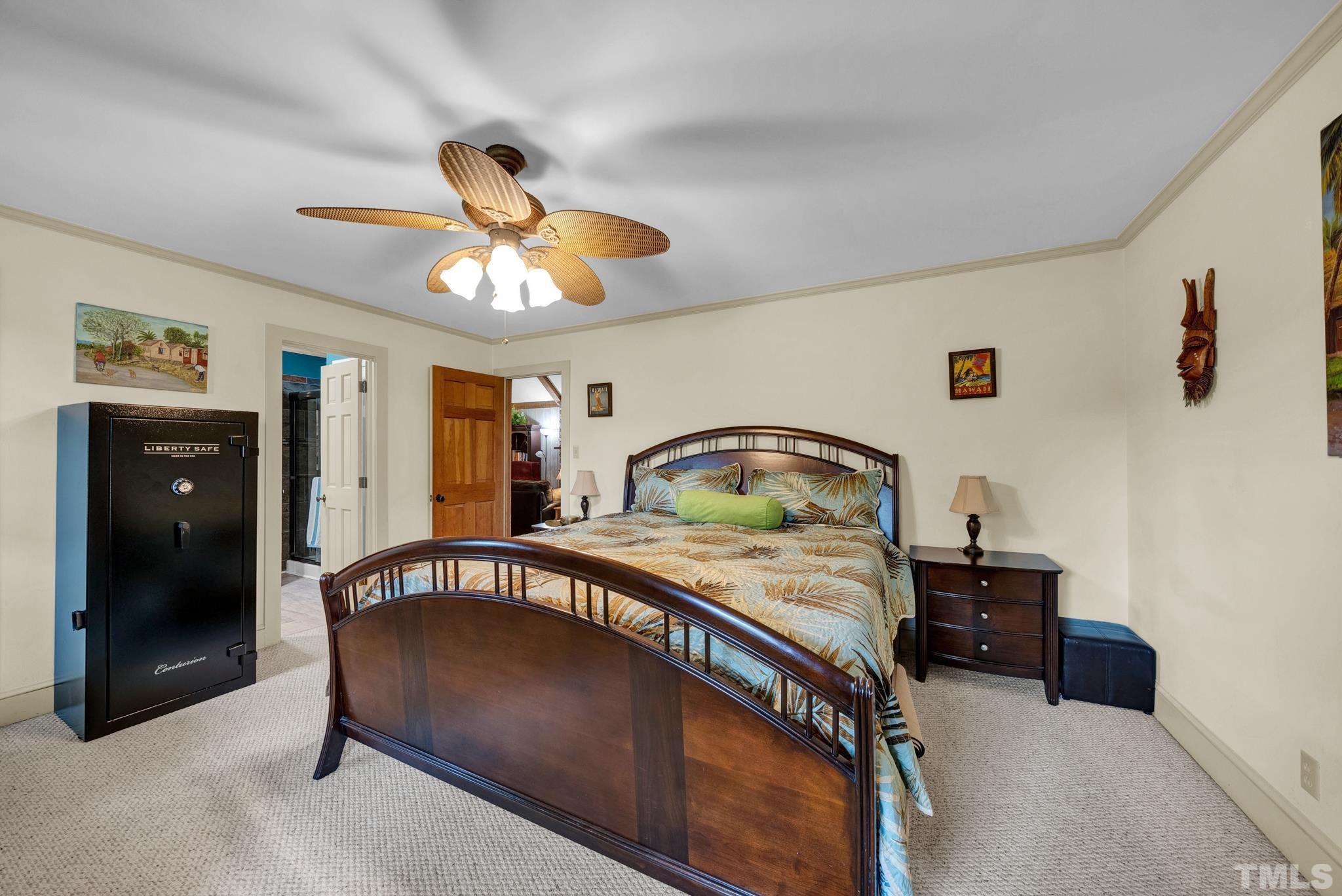 3614 Holly Grove Road Benson, NC 27504 - Photo 19 of 30 a bedroom with a bed and a chandelier