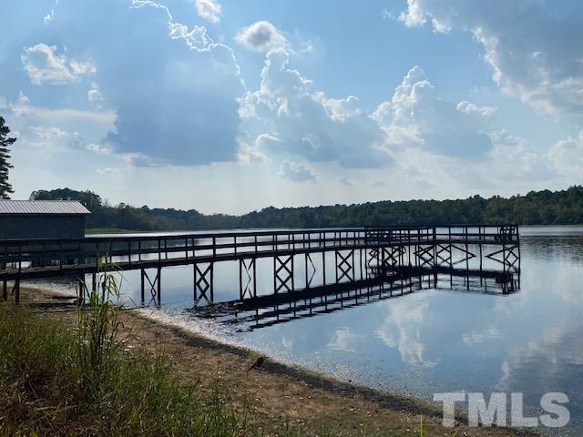 3614 Holly Grove Road Benson, NC 27504 - Photo 27 of 30 a view of swimming pool with lake and houses in the back