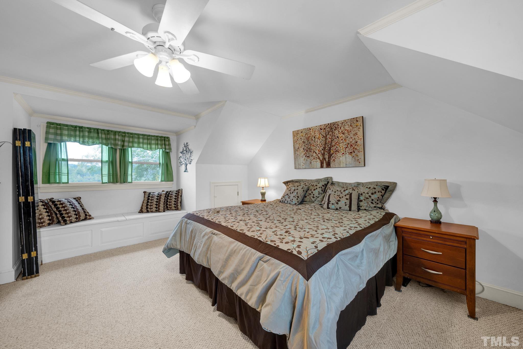 3614 Holly Grove Road Benson, NC 27504 - Photo 3 of 30 a bedroom with a large bed a couch and a chandelier