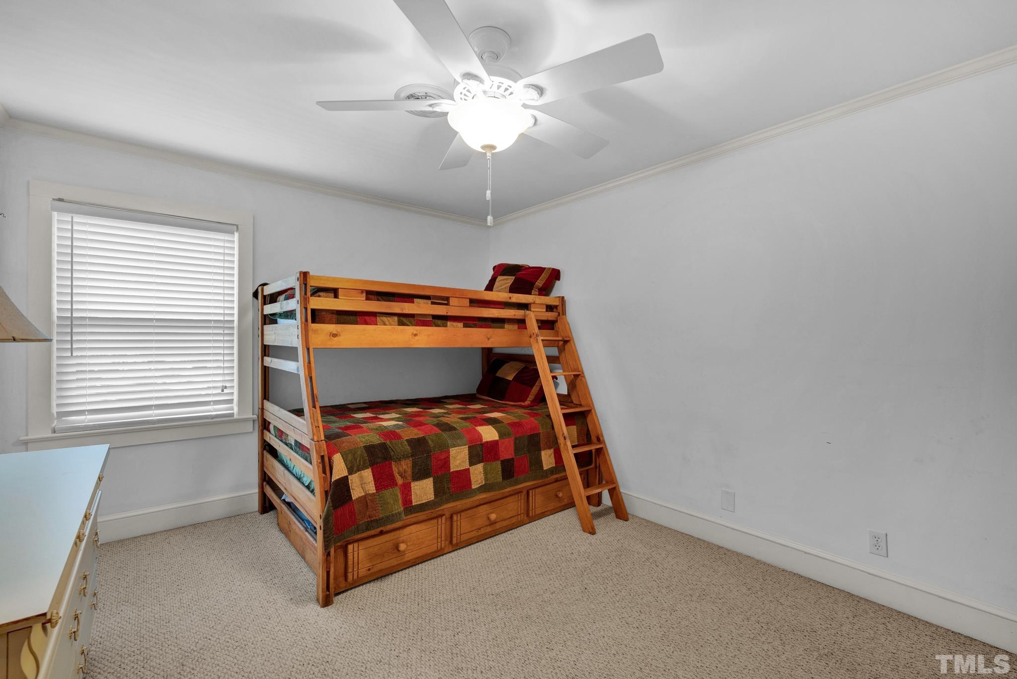 3614 Holly Grove Road Benson, NC 27504 - Photo 7 of 30 a bedroom with a bed and a chandelier