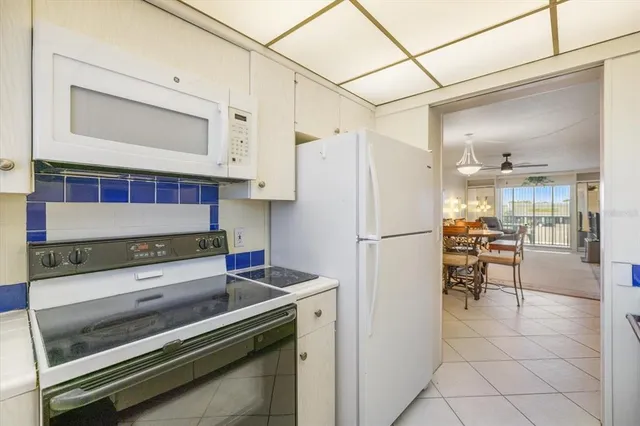 a kitchen with stainless steel appliances a refrigerator and a stove top oven