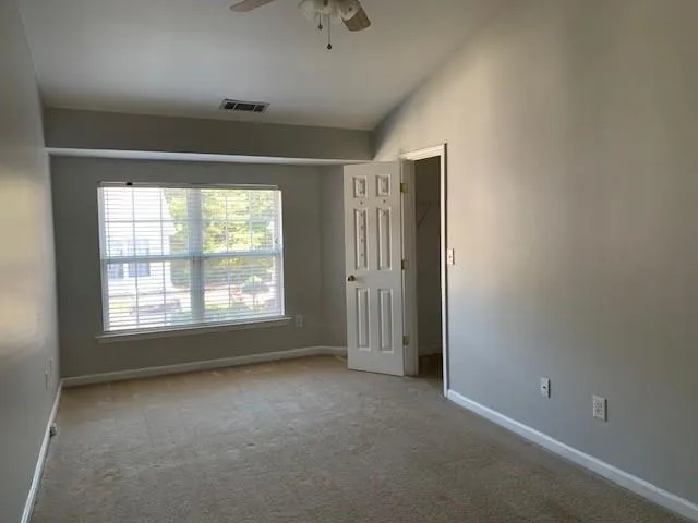 an empty room with a empty space and windows