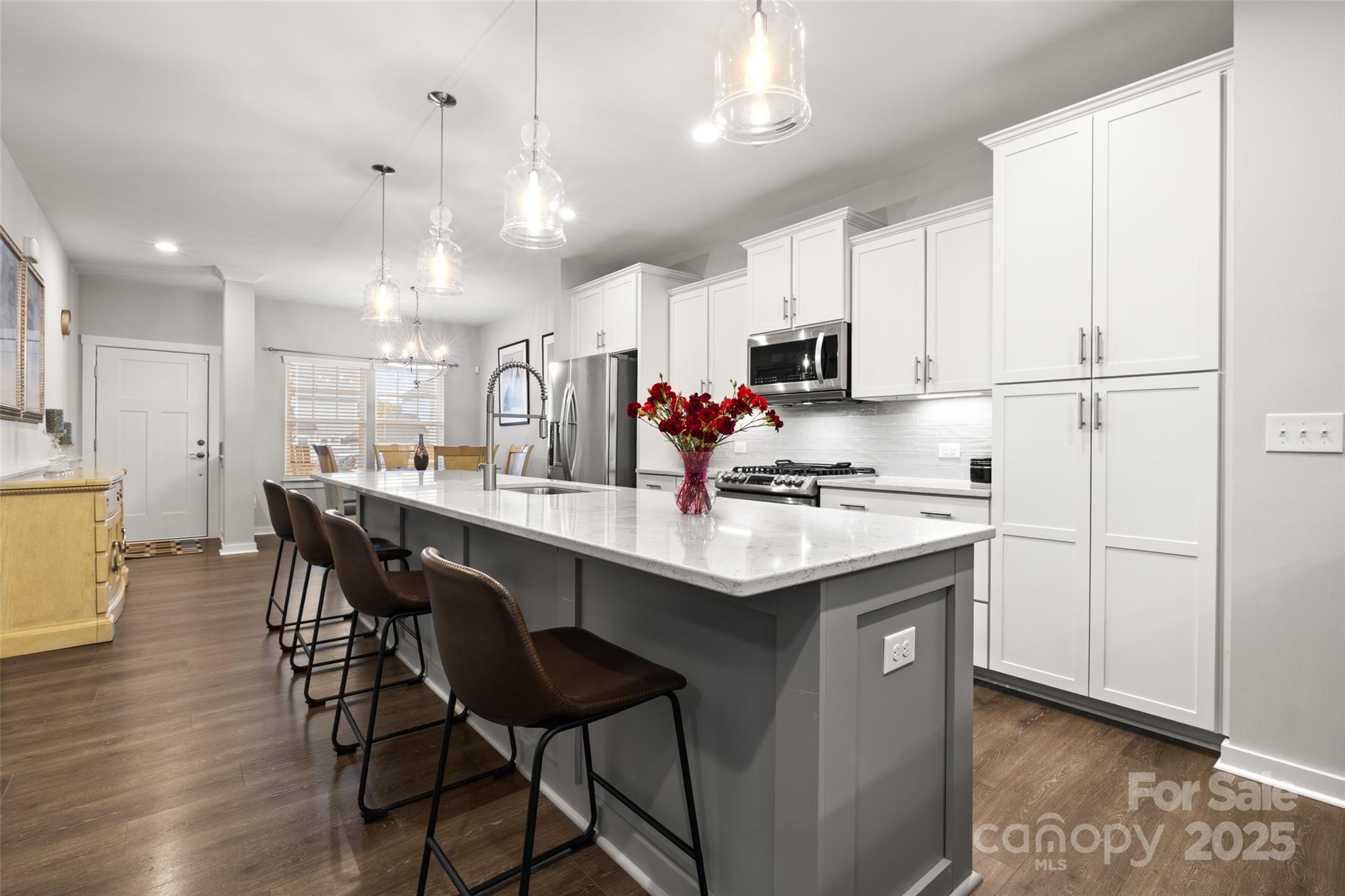 23115 Goose Down Lane Lancaster, SC 29720 - Photo 4 of 45 a kitchen with kitchen island granite countertop a sink cabinets and wooden floor