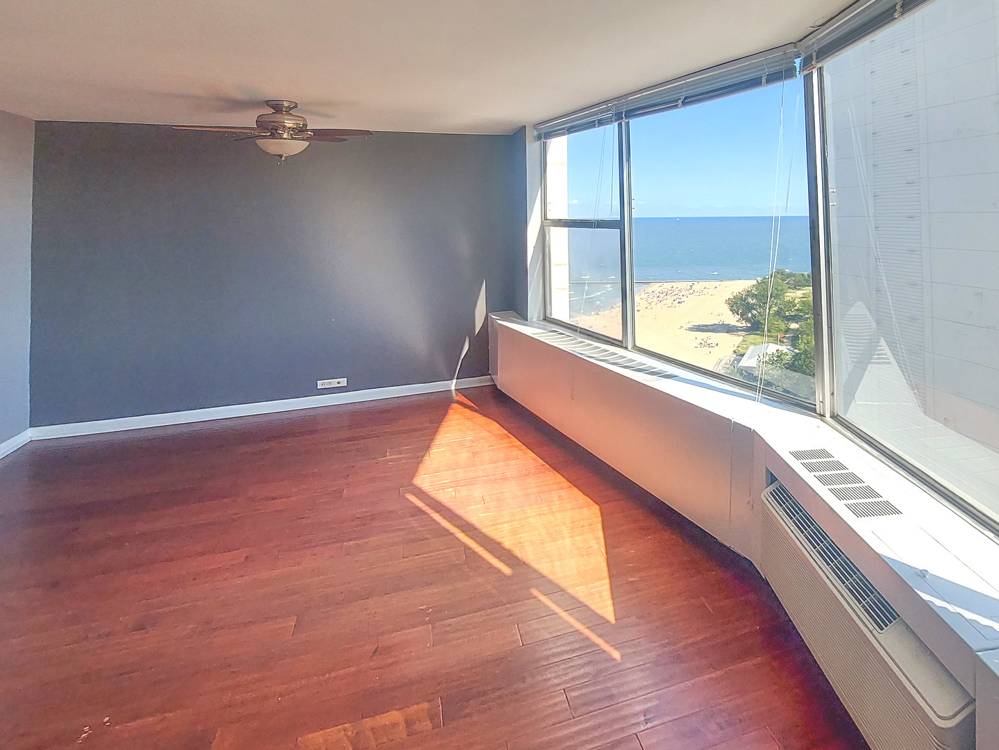 5757 North Sheridan Road, Unit 20F Chicago, IL 60660 - Photo 2 of 35 a view of a room with wooden floor and windows