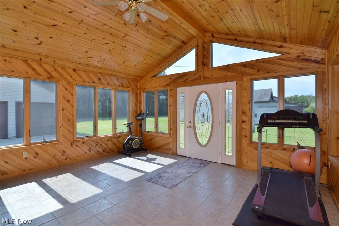 15227 Leroy Road Thompson, OH 44086 - Photo 33 of 50 Morning Room. Andersen windows. Vaulted ceiling with ceiling fan. Ceramic flooring. Could be a sunroom, dinette, craft room. Door leads to the rear of the property.