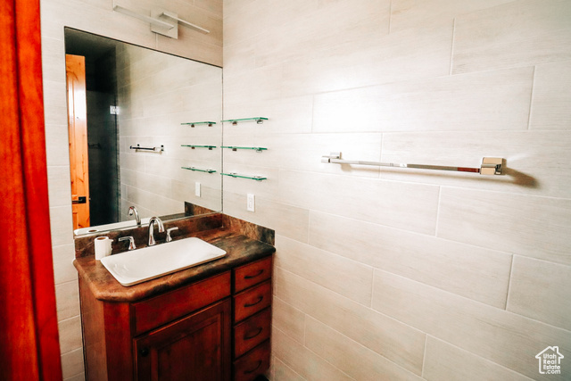 985 Russell Road Hatch, UT 84735 - Photo 15 of 30 Bathroom featuring vanity and tile walls