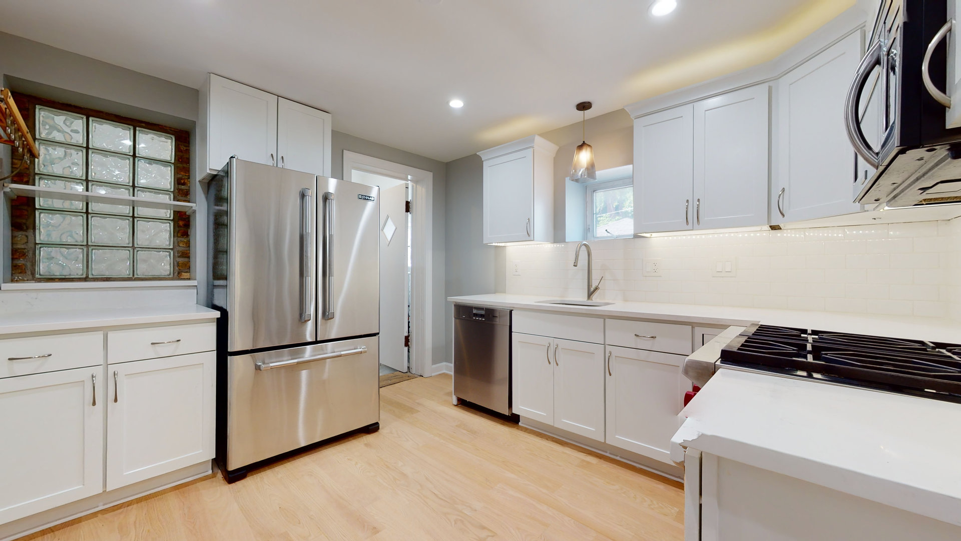 1543 West George Street, Unit 1 Chicago, IL 60657 - Photo 8 of 18 a kitchen with a refrigerator and a sink