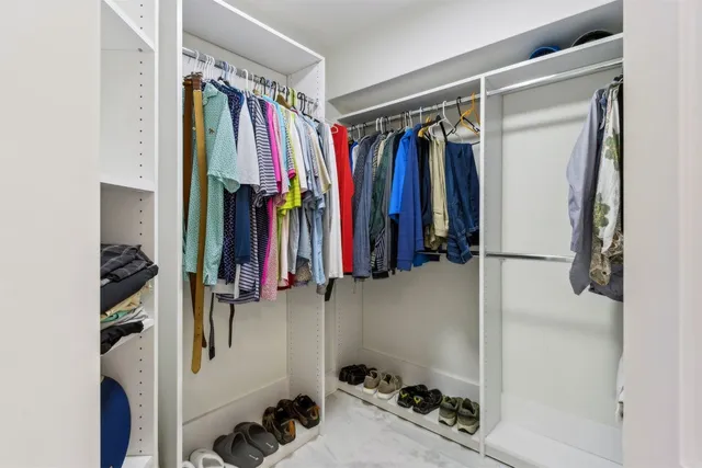 an aerial view of a house with a yard swimming pool a patio and lake view