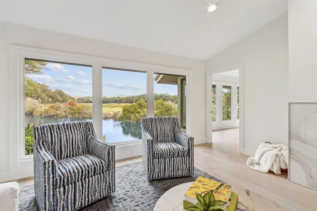 a living room with furniture fireplace and a large window