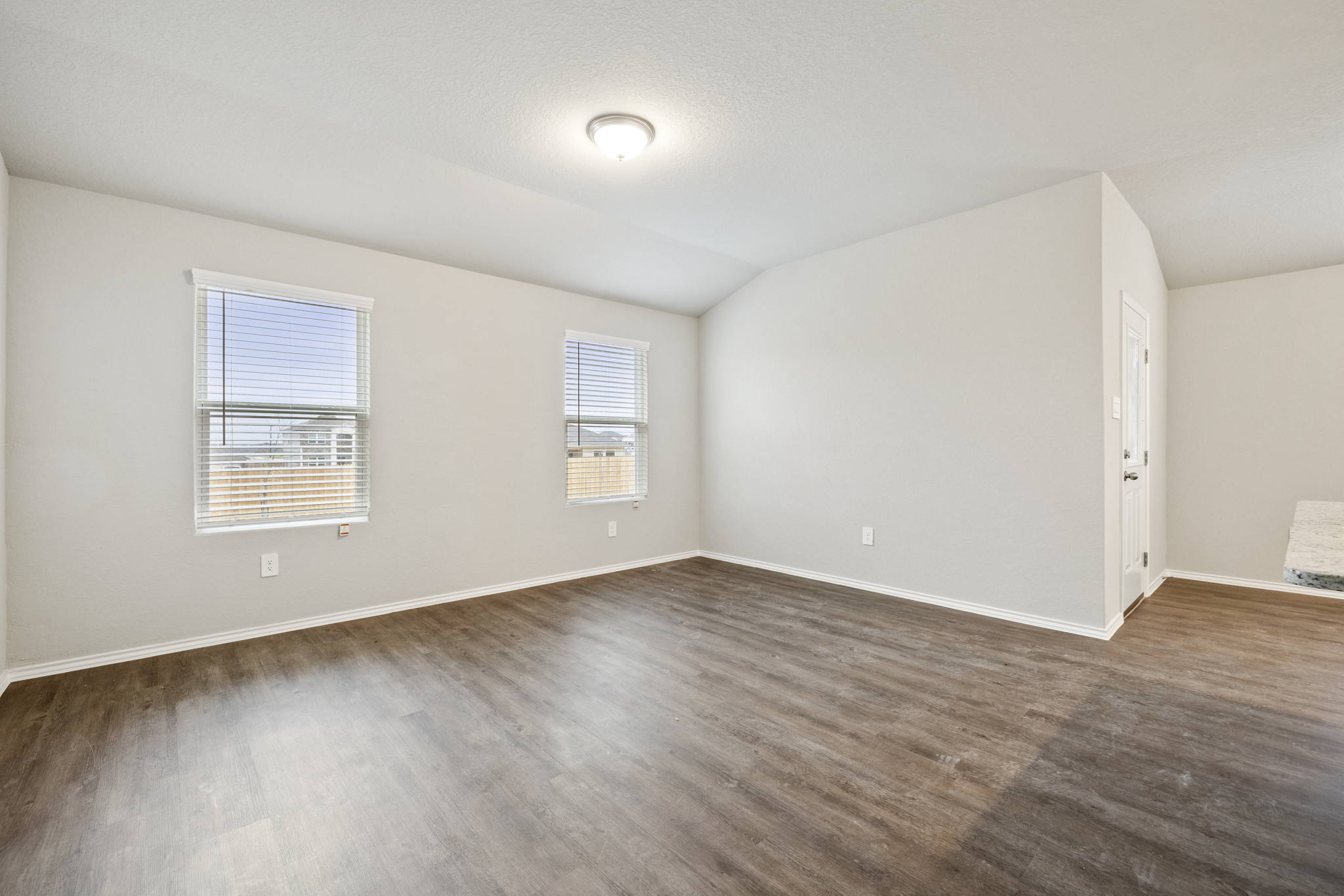 3209 Ridge Place Seguin, TX 78155 - Photo 11 of 23 Unfurnished room with vaulted ceiling and dark wood-style floors