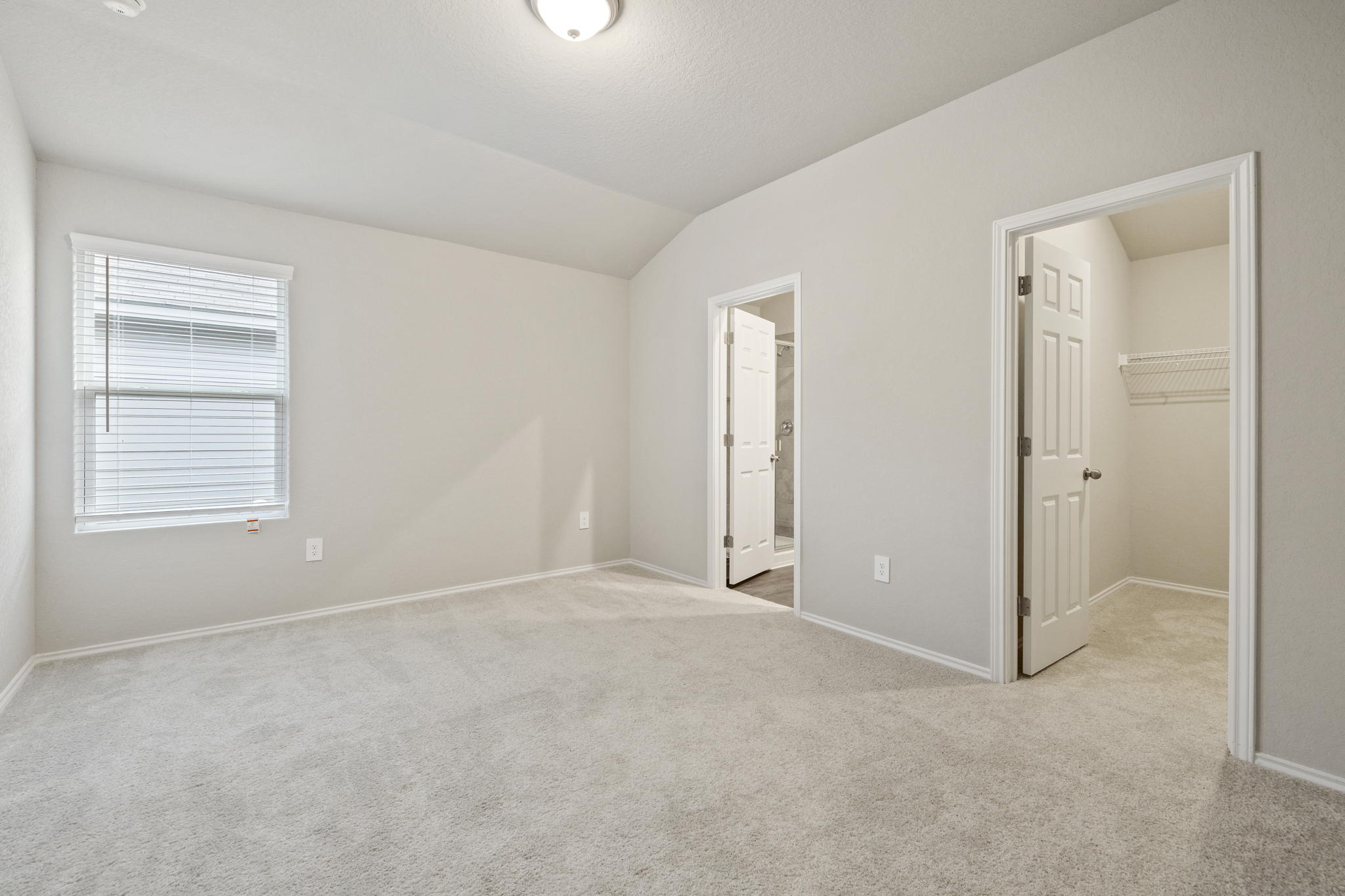 3209 Ridge Place Seguin, TX 78155 - Photo 12 of 23 Unfurnished bedroom with a spacious closet, light colored carpet, and lofted ceiling