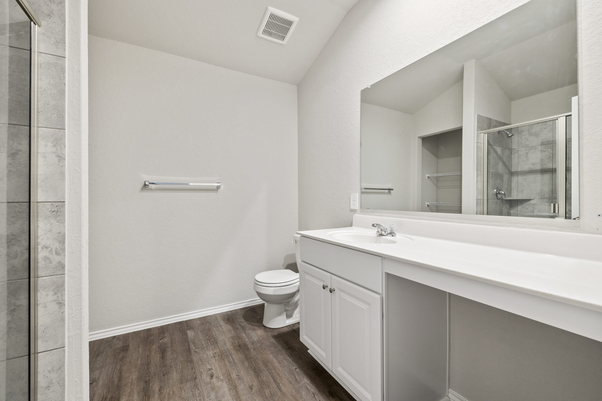 3209 Ridge Place Seguin, TX 78155 - Photo 14 of 23 Full bath with a shower stall, vanity, dark wood-style floors, and lofted ceiling