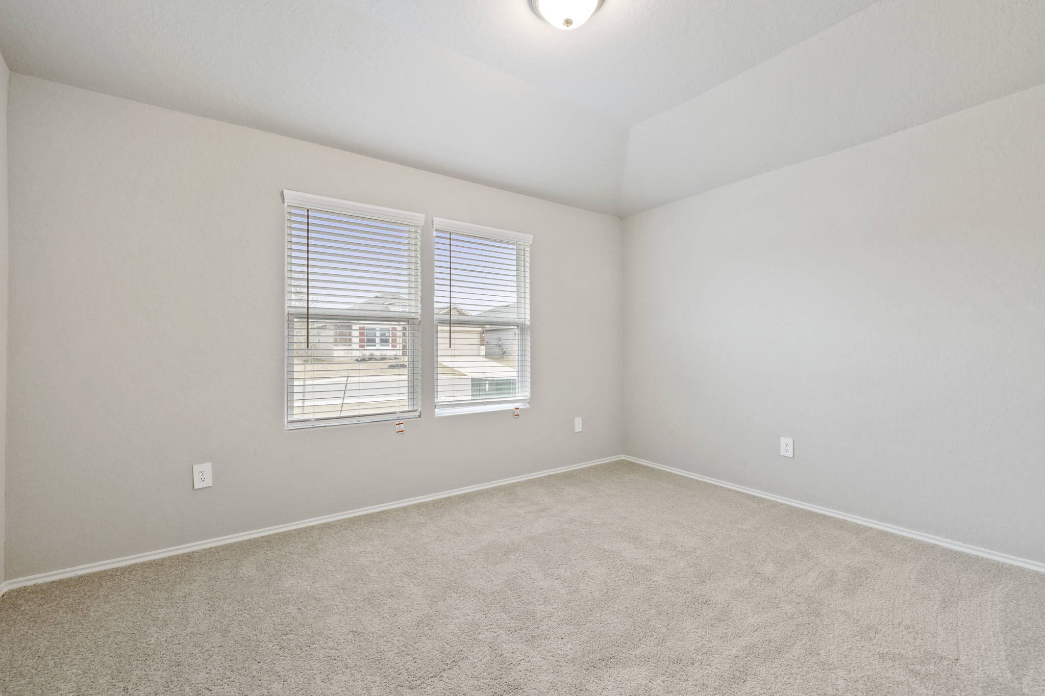 3209 Ridge Place Seguin, TX 78155 - Photo 17 of 23 Unfurnished room with light colored carpet and vaulted ceiling