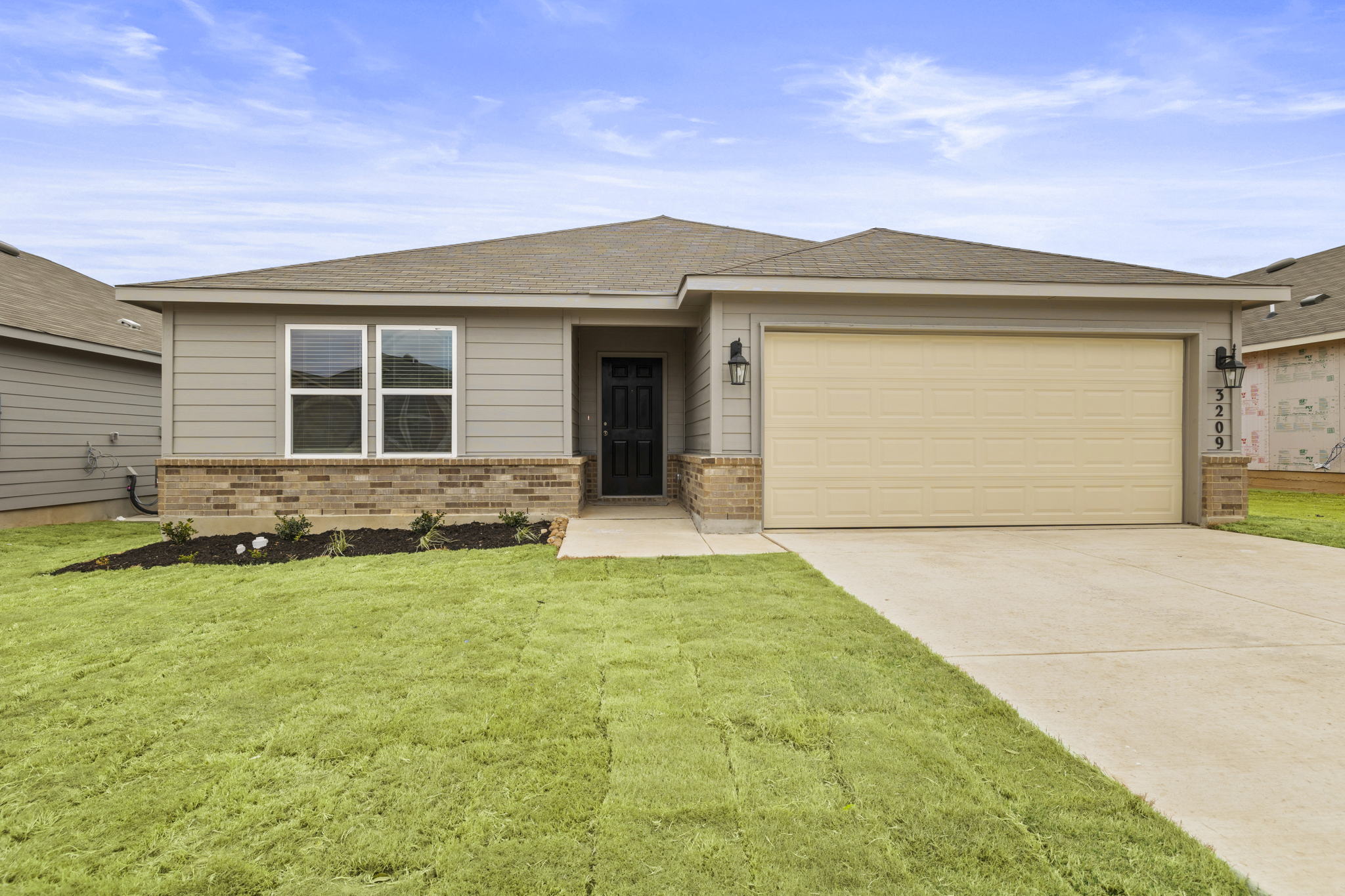 3209 Ridge Place Seguin, TX 78155 - Photo 2 of 23 View of front of property with an attached garage, brick siding, driveway, a front yard, and a shingled roof
