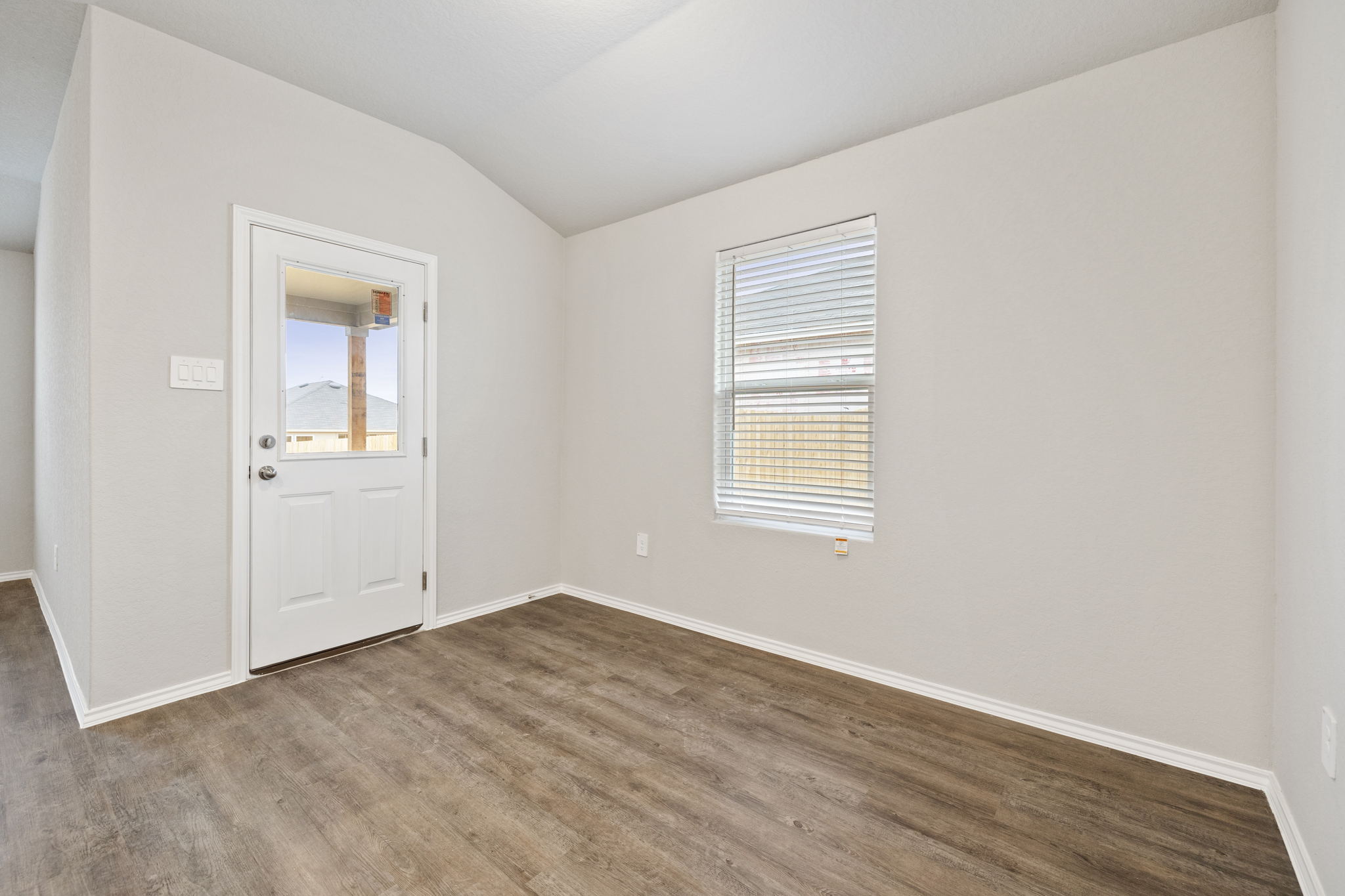3209 Ridge Place Seguin, TX 78155 - Photo 7 of 23 Unfurnished room with vaulted ceiling, plenty of natural light, and dark wood-type flooring