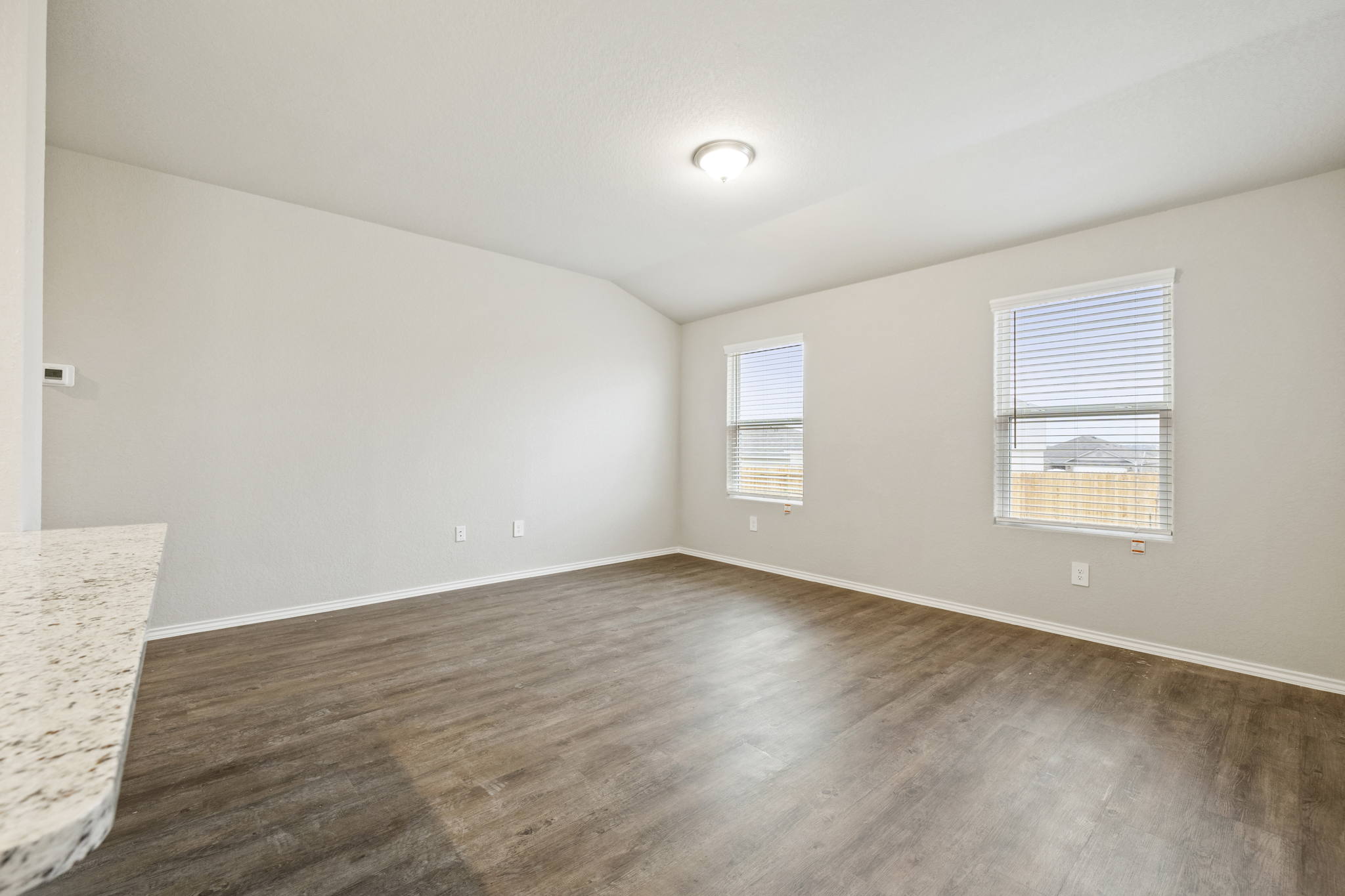 3209 Ridge Place Seguin, TX 78155 - Photo 9 of 23 Unfurnished room featuring lofted ceiling and dark wood-style floors